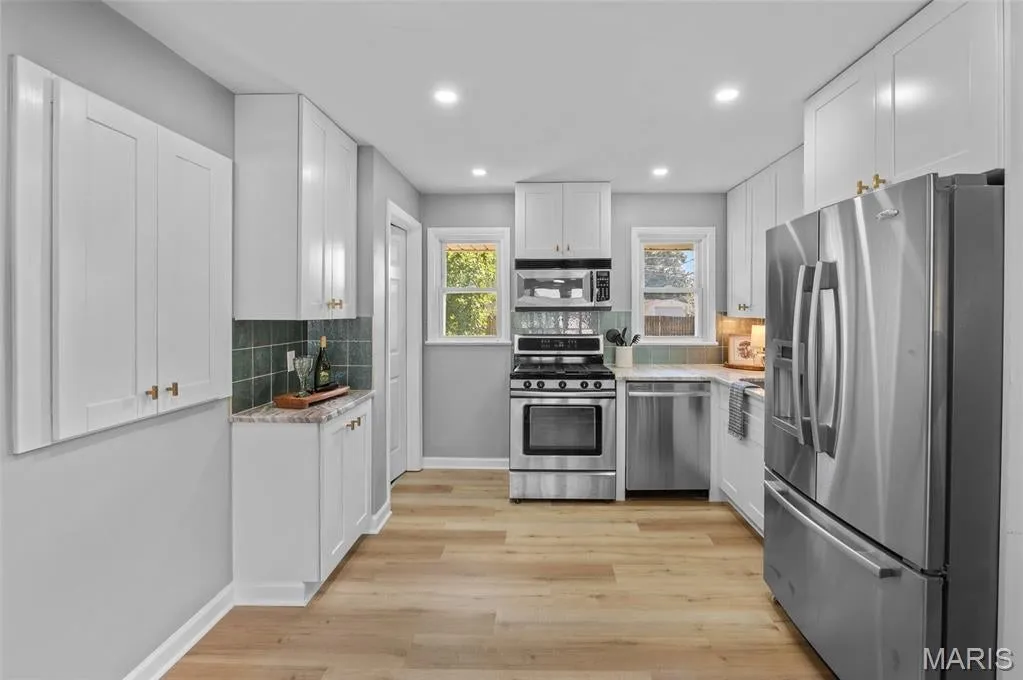 Designer kitchen with stainless appliances and stone counters