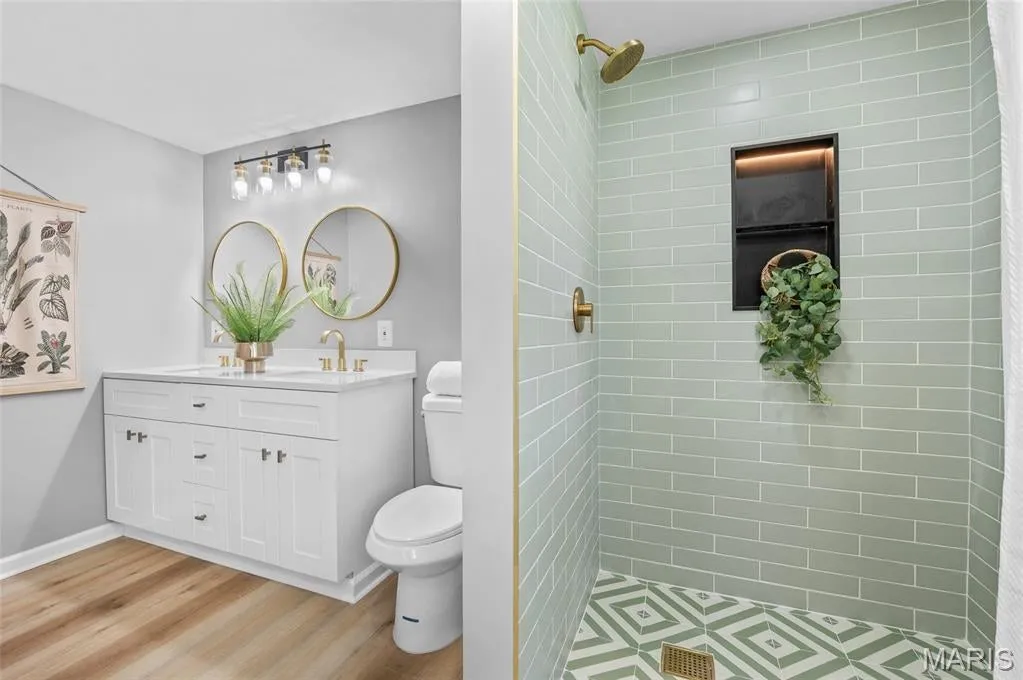 Spa-inspired bathroom with heritage-green tile and brass fixtures
